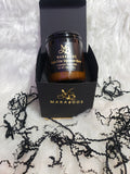 Maraboo's CoCo Elite Signature Blend candle in a black box on a textured white background with black lace.